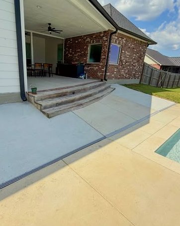 Covered porch with concrete steps and a stained pool patio with a trench drain in Kannapolis, NC