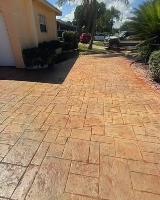 Terracotta colored stamped concrete driveway with a slate pattern in Kannapolis, NC